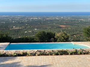 a swimming pool with a view of a city at Dimora Le Ginestre in Fasano