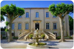 a building with a fountain in front of it at Château des Fontaines in Canet d'Aude