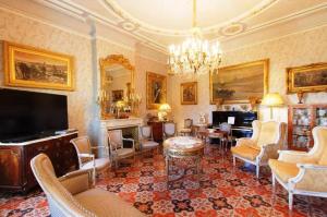 a living room filled with furniture and a flat screen tv at Château des Fontaines in Canet d'Aude