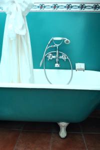 a bath tub in a bathroom with a blue wall at Villa Fausta B&B in Trieste