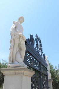 a statue of a man standing next to a gate at Pansion Ana in Podaca