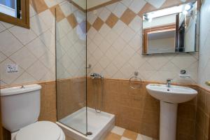 a bathroom with a shower and a toilet and a sink at Villa Katerina in Potos