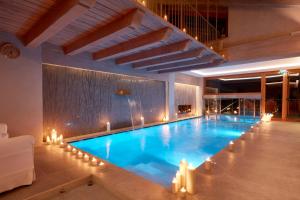 a large swimming pool with candles in a building at Auberge de La Maison in Courmayeur