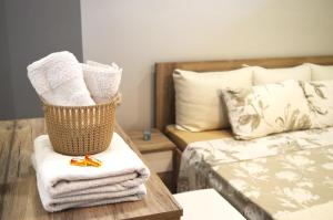 
a bed with a basket on top of it next to a pillow at Antigona Apartments in Skopje
