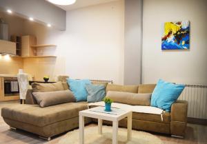 a living room with a couch and a table at Antigona Apartments in Skopje
