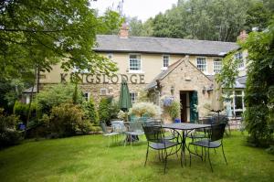 a table and chairs in front of a building at The Kingslodge Inn - The Inn Collection Group in Durham