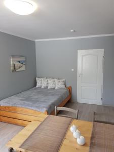a bedroom with a bed and a wooden table at Elexia in Sianozety