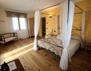 a bedroom with a bed with a canopy at Il Poggio di Maro' in Badalucco