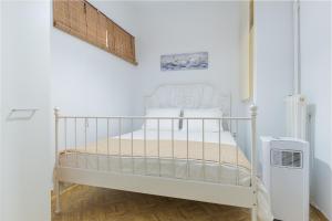 a white crib in a room with a radiator at Alsos Family Apartment in Corfu
