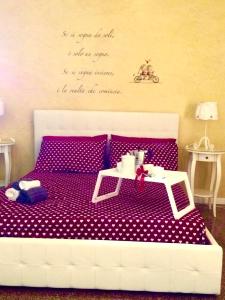 a bedroom with a bed with a table on it at affitto turistico San Pietro in Rome