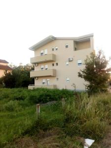 a large building in the middle of a field at Tufio Apartmani Ulcinj in Ulcinj