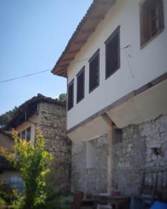 a building with windows on the side of it at Dhimitri's guest house in Berat