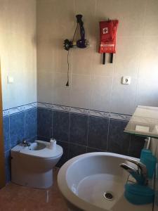 a bathroom with a toilet and a tub and a camera at Arenales del Sol in Arenales del Sol
