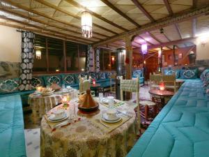 a dining room with tables and chairs in a restaurant at Toubkal Garden in Imlil