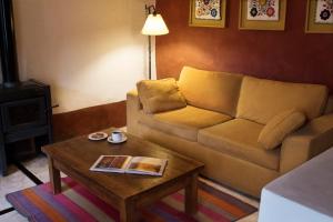 a living room with a couch and a coffee table at Posada de Luz in Tilcara