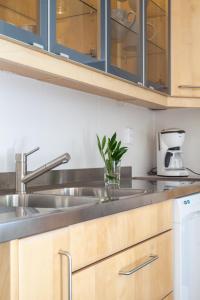 a kitchen with wooden cabinets and a sink at Gränna Lakeview in Gränna