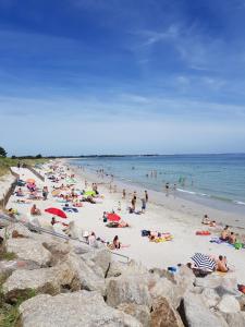 a large group of people on a beach at Ty Polder in Île-Tudy