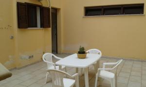 a white table and chairs with a potted plant on it at Villa Belvedere in Nardò