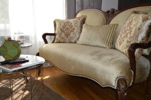 a couch with pillows on it in a living room at Parliament Sofia - Top Center Luxury Apartment in Sofia