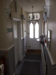 a hallway with a white door and a window at Bay Lodge in Aylesbury