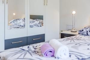 a bedroom with a bed with towels on it at Apartment Rusula in Milna +31 photos