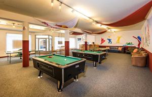 a billiard room with two pool tables in it at Jugendgästehaus Tauernruh in Radstadt