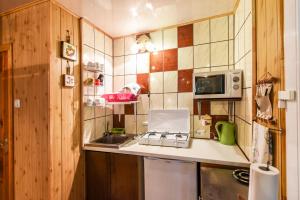 a small kitchen with a sink and a microwave at Šturmų Sodyba in Ventė