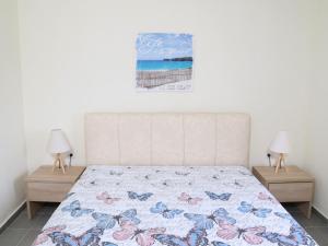 a bedroom with a bed and two nightstands at House for Relaxing Vacations in Keramoti