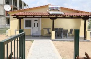 a pergola with a table and chairs on a patio at House for Relaxing Vacations in Keramoti