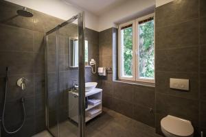 a bathroom with a shower and a toilet and a sink at Central Luxury Rooms in Omiš