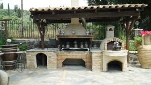 an outdoor kitchen with an outdoor oven in a yard at Spiti Nikos in Danilia