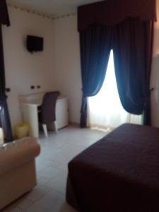 Postel nebo postele na pokoji v ubytování Hotel Madonna Delle Grazie
