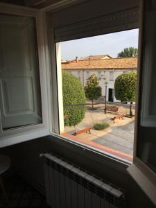 a window in a room with a view of a courtyard at LA FARMÀCIA in LʼAmetlla de Merola