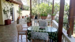 a patio with a table and chairs on a porch at Anna's Apartment and Studio in Artemida