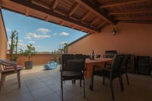 a dining room with a table and chairs on a patio at Villa Lucija Vodice in Vodice