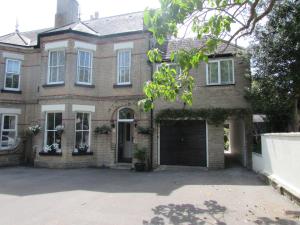 a large brick house with a garage at The Loft Apartment in Weymouth