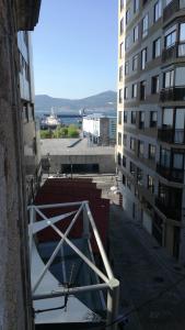a view of an alley between two tall buildings at Hostal Continental in Vigo