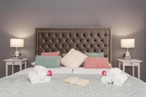 een slaapkamer met een bed met handdoeken en boeken bij Luxury Rooms Saint Jacob in Trogir