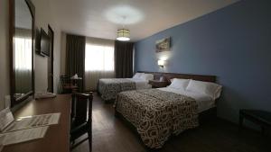 Postel nebo postele na pokoji v ubytování Hotel El Greco