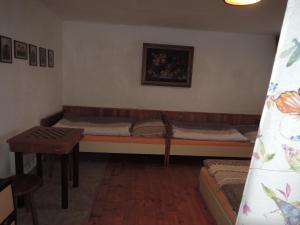 a room with two beds and a table in it at Chalupa na Šumavě in Javorná