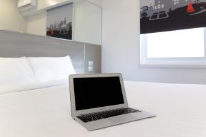 a laptop computer sitting on a table in a bedroom at Red Planet Manila Bay in Manila