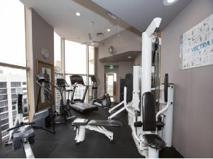 a gym with several tread machines in a room at Quay West 2007- Self Catering in Sydney