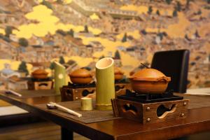 a wooden table with bowls and chopsticks on it at Hotel Binario Saga Arashiyama in Kyoto