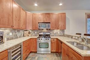 a kitchen with wooden cabinets and a stove top oven at 6509 Settlers Creek Townhomes in Keystone