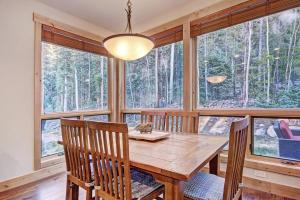 a dining room with a table and chairs and windows at 6509 Settlers Creek Townhomes in Keystone