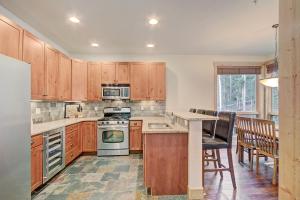 a kitchen with wooden cabinets and a table and chairs at 6509 Settlers Creek Townhomes in Keystone