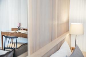 a hotel room with a desk with a bed and a lamp at Muzik Hotel - Ximending Xining Branch in Taipei