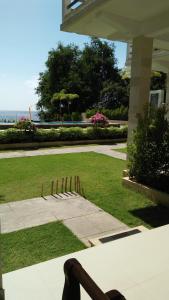 a person sitting at a table in a yard at Ocean Resort Amed in Amed