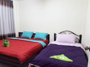 Postel nebo postele na pokoji v ubytování Mae Rampung Beach House คาราโอเกะและสระเด็ก