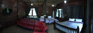um quarto com 2 camas e um sofá vermelho em สวนฉัน Igarden em Ban Pang Champi